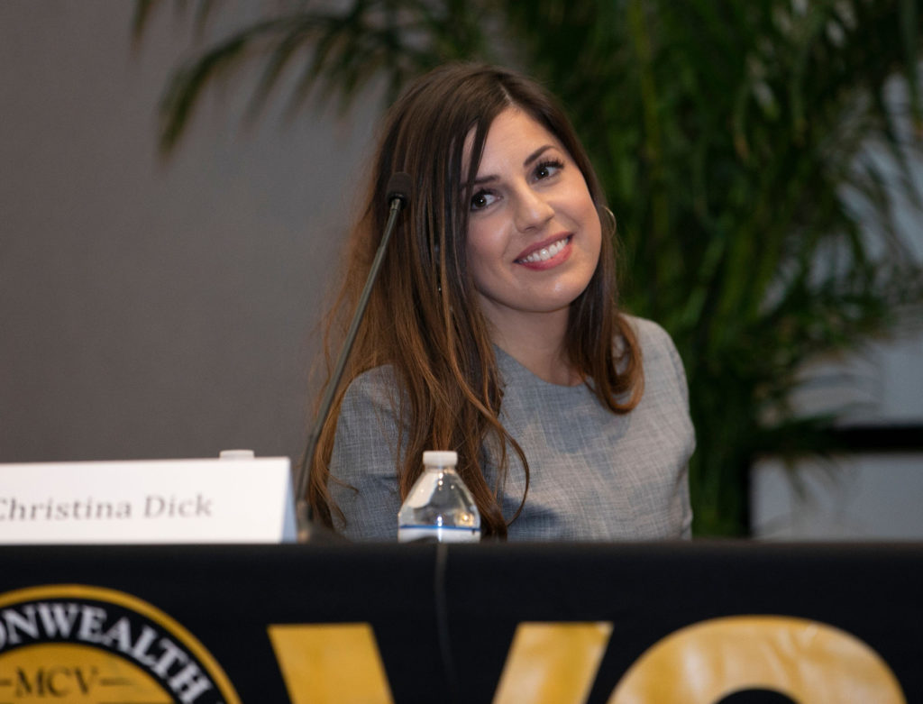 christina at table with vcu logo on it