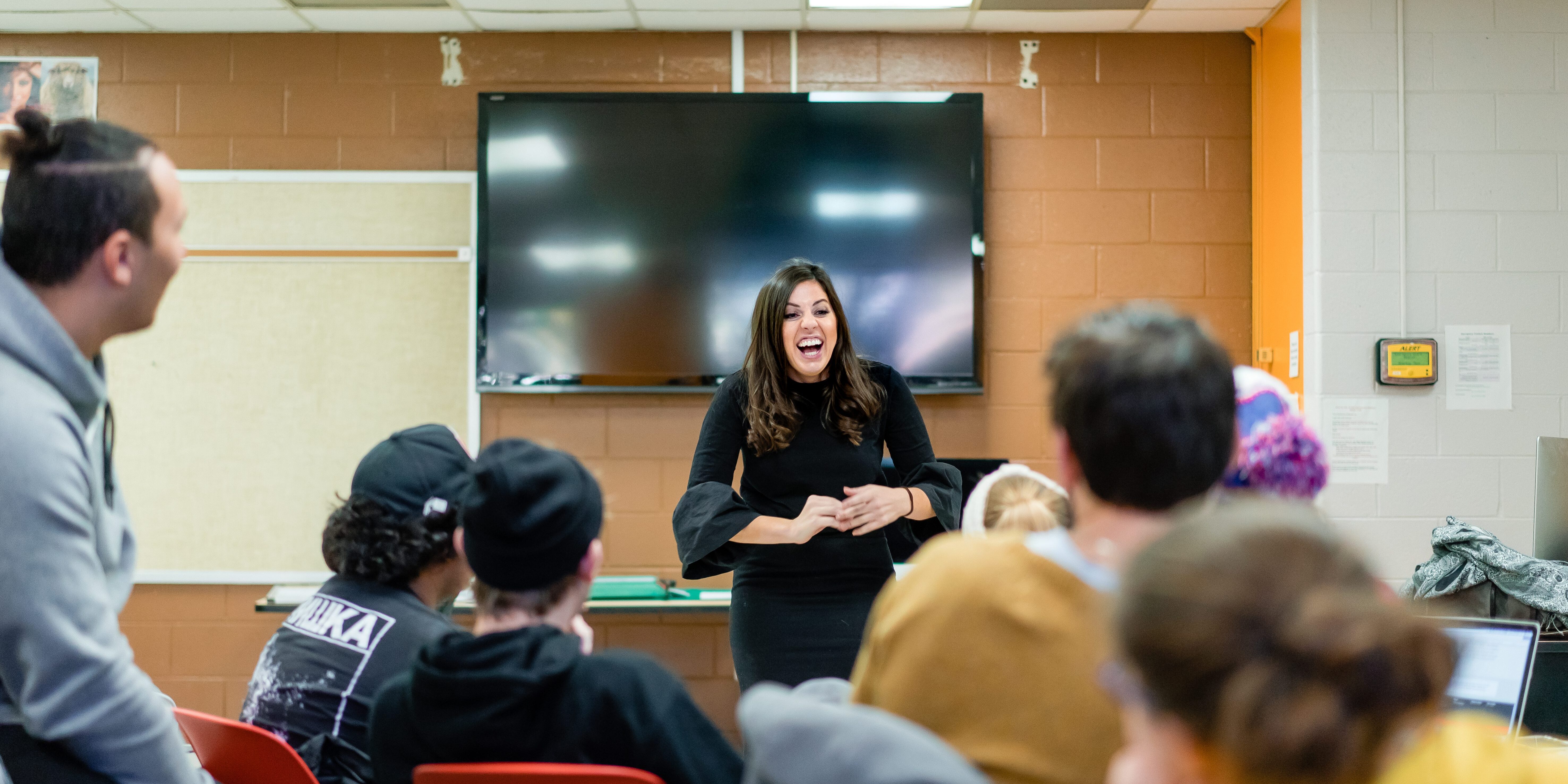 Christina Teaching 2 Christina speaking in front of group of students